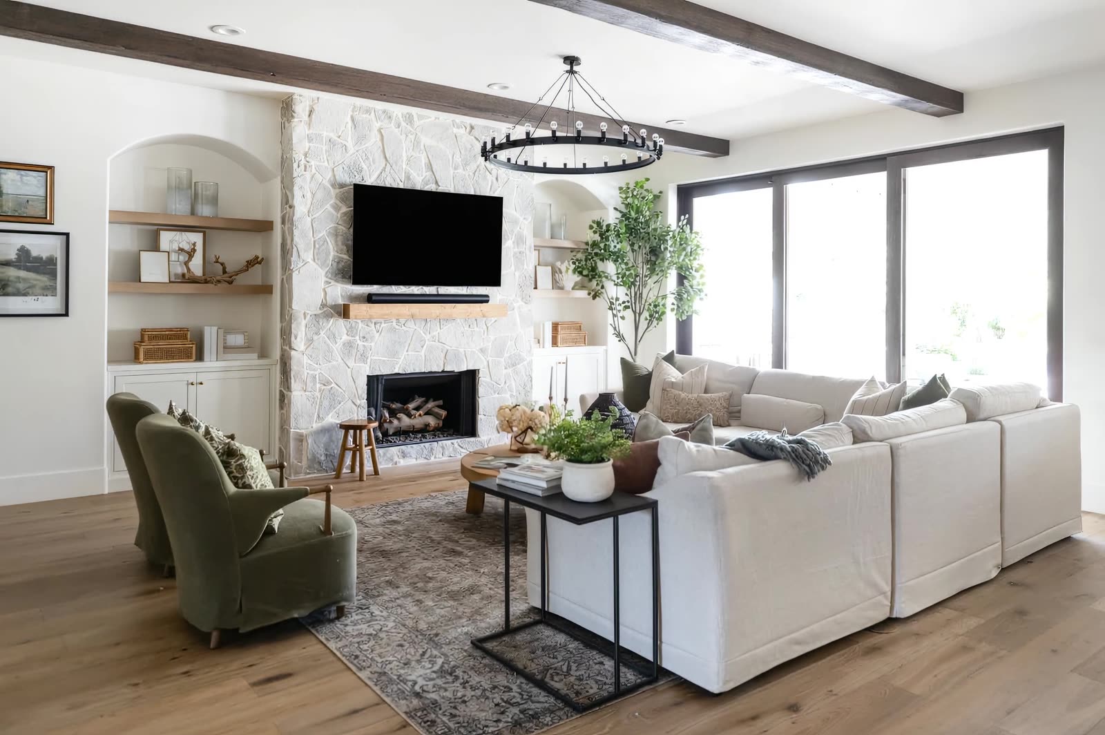 Finished living room with wood beams, layered textiles and styled shelves